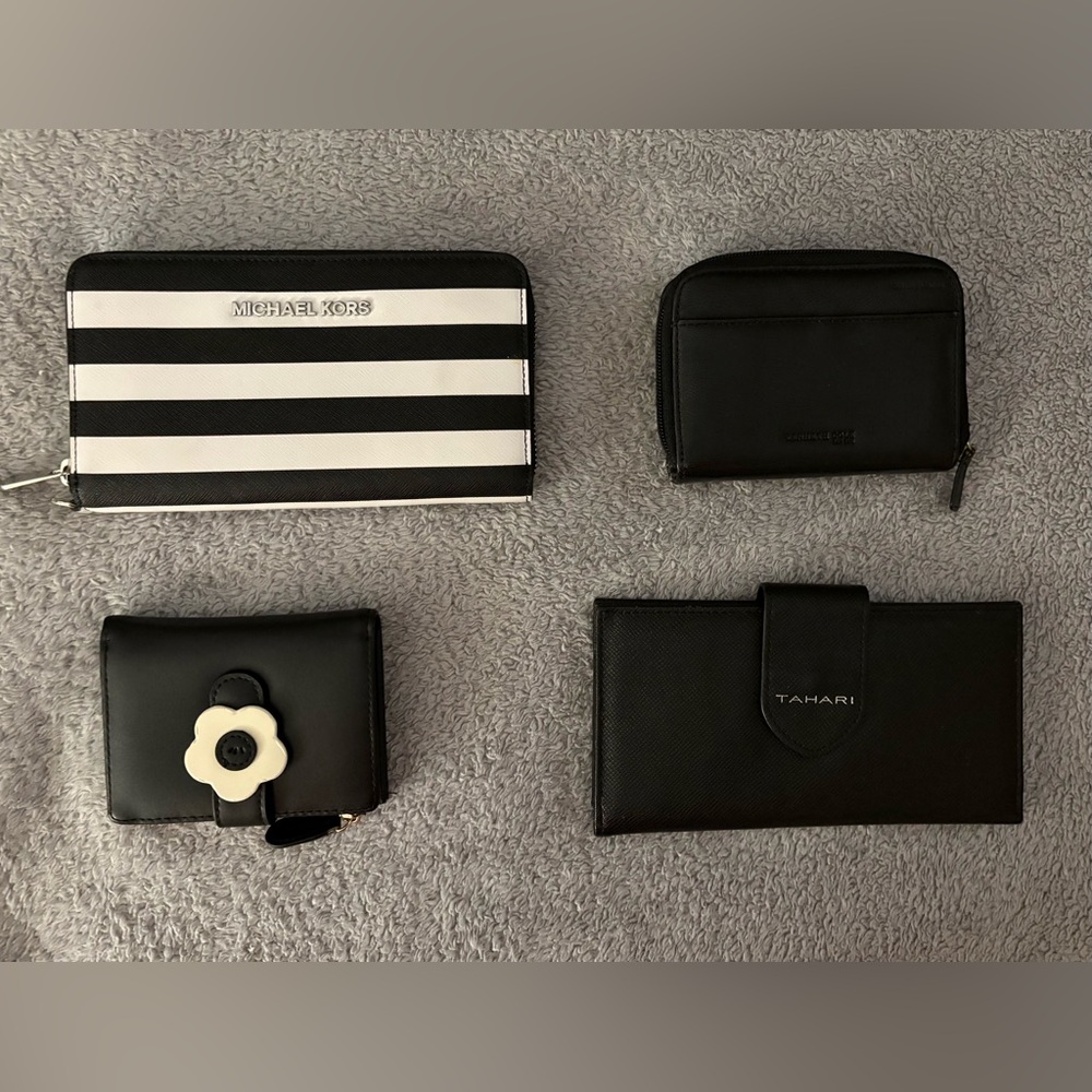 Group of four black leather wallets. Different brands and different sizes.  $40.